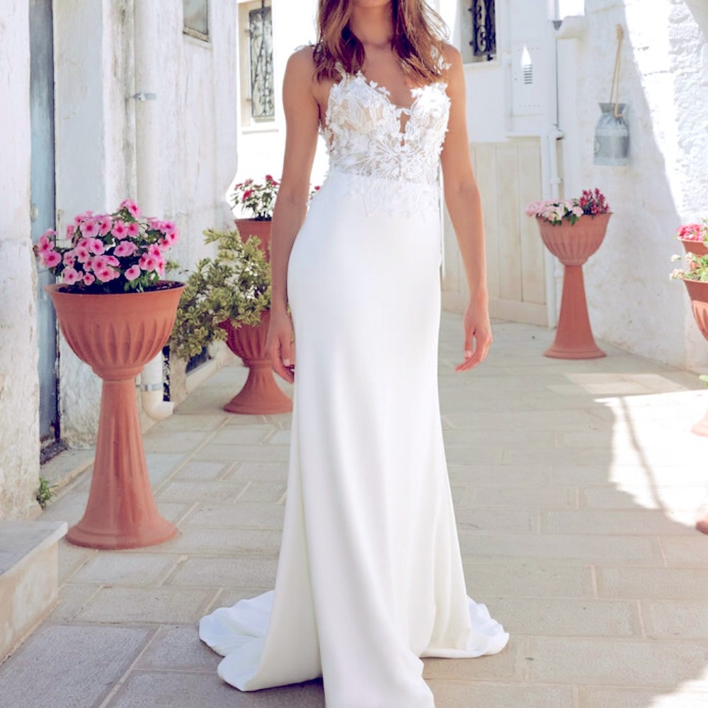 Never worn or altered wedding dress, size 12 but fits a size 4 jeans well.